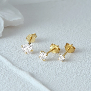 Detailed macro view of S925 sterling silver gold-plated heart and round zircon studs