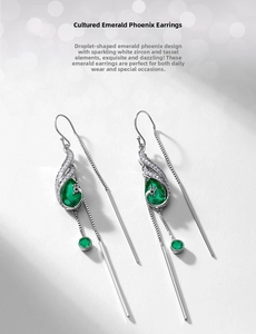 Detailed close-up of peacock earrings featuring emerald gemstones and silver tassels
