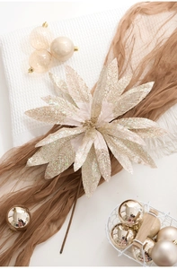 Close-up of champagne gold glitter poinsettia flower for elegant Christmas tree decoration