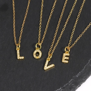 Gold plated initial necklaces spelling LOVE with sparkling zircon inlaid pendants