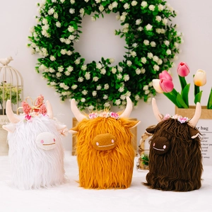Three Highland Cow plush toys in white and brown colors with floral headbands