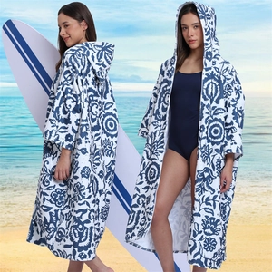 Microfiber hooded beach poncho with blue mandala pattern shown on a sunny beach