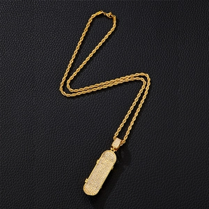 Hip hop gold plated iced out scooter pendant with twist chain on black leather surface