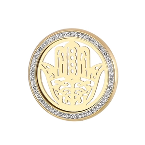 Macro detail of golden Hamsa Hand pendant featuring sparkling rhinestones on the outer rim