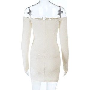 Macro detail of off-white embossed fabric and stitching on a backless bodycon dress