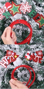 Detail of red Christmas headband with sparkling stars and trees held against a snowy tree