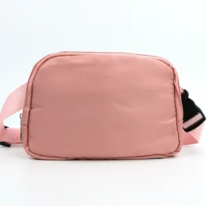 Detail of pink nylon running belt bag showing high-density fabric and durable plastic buckle