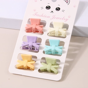 Set of 6 colorful pastel mini hair claws on a cat display card for women styling