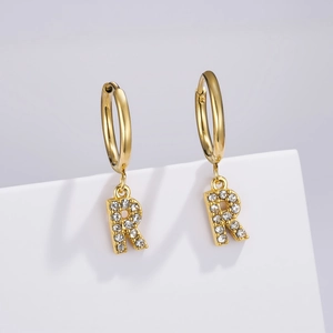 Macro shot of gold letter R dangle earrings with sparkling pave-set cubic zirconia crystals