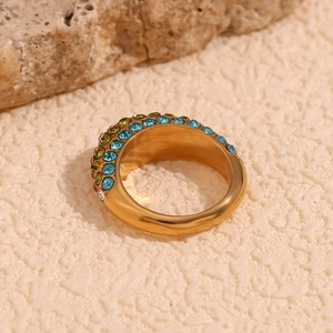 Detail of 18K gold plated wide ring featuring colorful micro-set zircons on sand stones