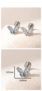 Macro shot of butterfly stud earrings with blue and clear marquise cut cubic zirconia