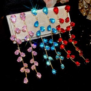 Detailed close-up of water-drop zircon tassel earrings in pink blue and red gemstone colors