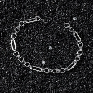 Close-up of hip hop stainless steel chain with rectangular links on black gravel