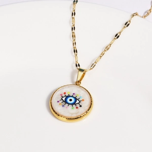 Detailed close-up of golden evil eye necklace with colorful enamel dots and blue eye charm
