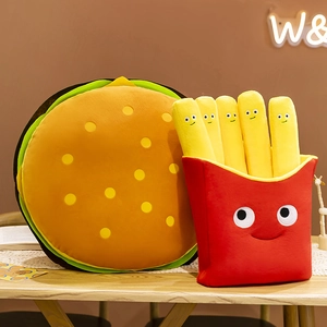Cute hamburger and French fries plush toys with smiling cartoon faces on wooden table