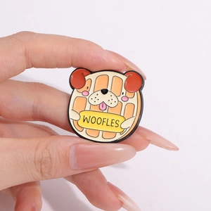 Close-up of creative enamel woofles pin featuring a puppy and waffle fusion design