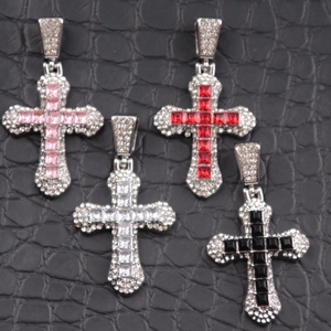 Detailed view of cross pendants with colorful square-cut crystals and pavé diamonds