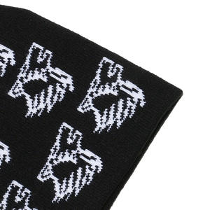 Detail view of high-quality black knit fabric with white eagle pattern and dense texture