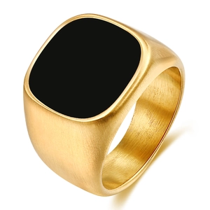 Detail of gold brushed stainless steel signet ring with a square black enamel face