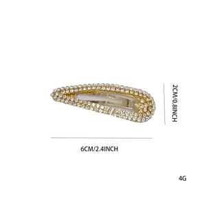 Detailed view of teardrop BB hair clip with white rhinestones on golden alloy base
