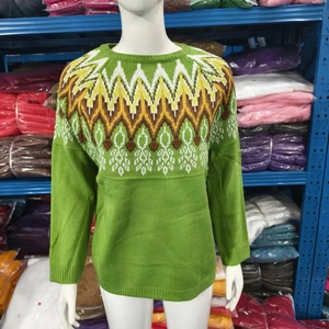 Detail of green Fair Isle knit sweater with colorful neck patterns on a model
