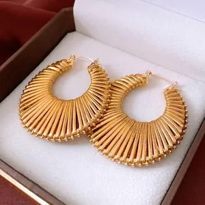 Vintage oversized gold hollow round earrings with pleated texture in a premium jewelry box