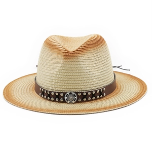 Close-up of western straw hat featuring brown leather band and metallic cross rivets