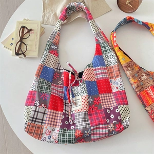 Detailed patchwork corduroy hobo bag featuring floral patterns and plaid textures