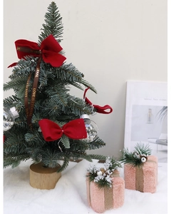 Mini Christmas tree with red bows and pink plush gift boxes for desktop decoration