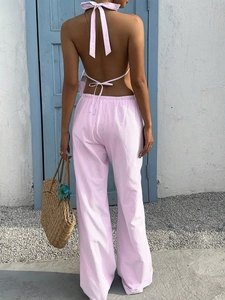 Rear view of a pink and white striped halter top and wide-leg trousers vacation set