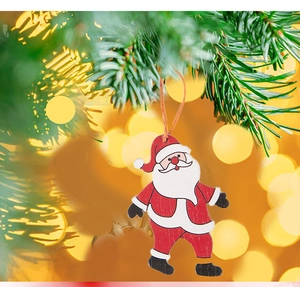 Close-up of a wooden gnome ornament with red and white patterns hanging on a Christmas tree