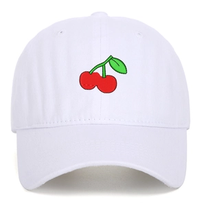 Close-up of red cherry embroidery detail on white cotton twill baseball cap