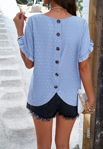 Detail of light blue polka dot blouse featuring back button design and ruffle sleeves