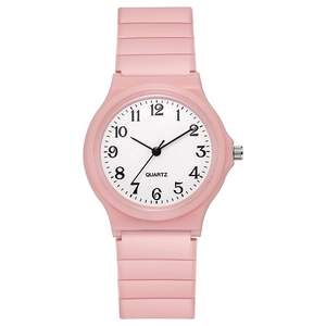 Close-up of pink minimalist quartz watch with round dial and silicone strap on white background
