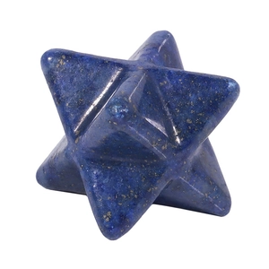 Detail of blue lapis stone Merkaba star pendant with natural gold flecks on white surface