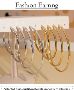 Macro shot of gold and silver stainless steel hoop earrings set in various sizes
