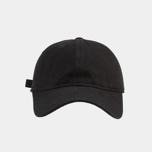 Detailed close-up of a classic black cotton twill six-panel baseball cap with ventilation eyelets