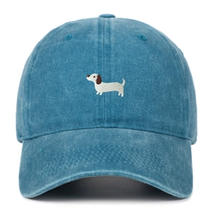 Close-up of blue washed cotton baseball cap featuring detailed dachshund dog embroidery