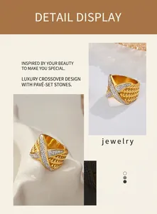 Macro view of gold plated wide band ring with crisscross pavé diamonds and woven texture