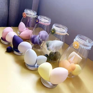 Colorful makeup sponge blender set in transparent jars with floral twine decoration