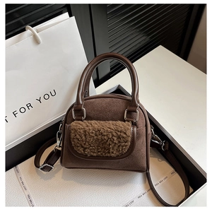 Detail showing plush fleece pocket and suede texture on a brown commuter handbag
