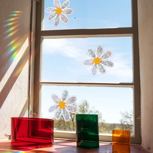 Rainbow laser daisy window stickers with colorful glass vases in natural sunlight