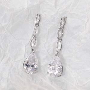 Macro view of luxurious marquise and pear cut zircon drop earrings in silver finish