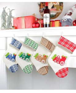 Set of 4 knitted Christmas stockings with festive train appliques on a fireplace
