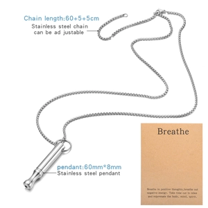 Macro detail of 528 Hz mindfulness breathing whistle pendant on adjustable chain