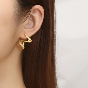 French vintage gold abstract geometric earrings with irregular twisted design on ear