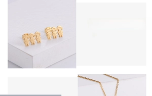 Close-up of gold-plated titanium steel little girl stud earrings and necklace set