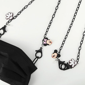 Detail of black mask chain featuring cartoon character charms and secure lobster clasps