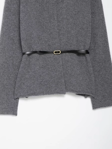 Detail of grey wool cardigan with a slim black leather belt and golden oval buckle