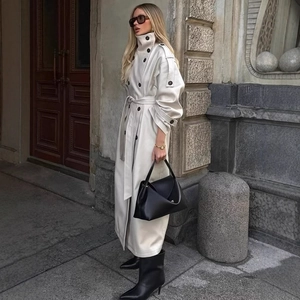 Women's long cream high collar trench coat with double-breasted buttons and waist tie belt